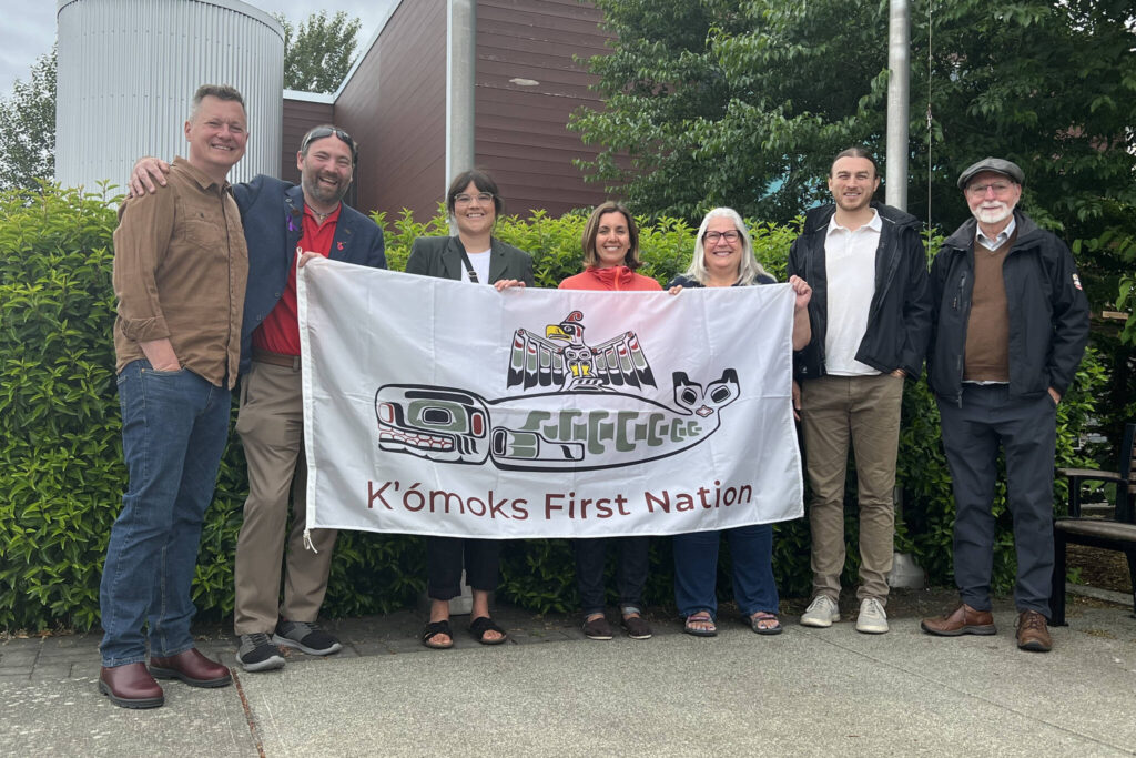 Councillor Candace Newman of K’ómoks First Nation (third from left) joins (l-r) Courtenay Coun. Will Cole-Hamilton, Mayor Bob Wells, Couns. Melanie McCollum, Wendy Morin, Evan Jolicouer and Doug Hillian at the raising o the K’ómoks First Nation flag, in recognition of National Indigenous Peoples Day, June 21.
